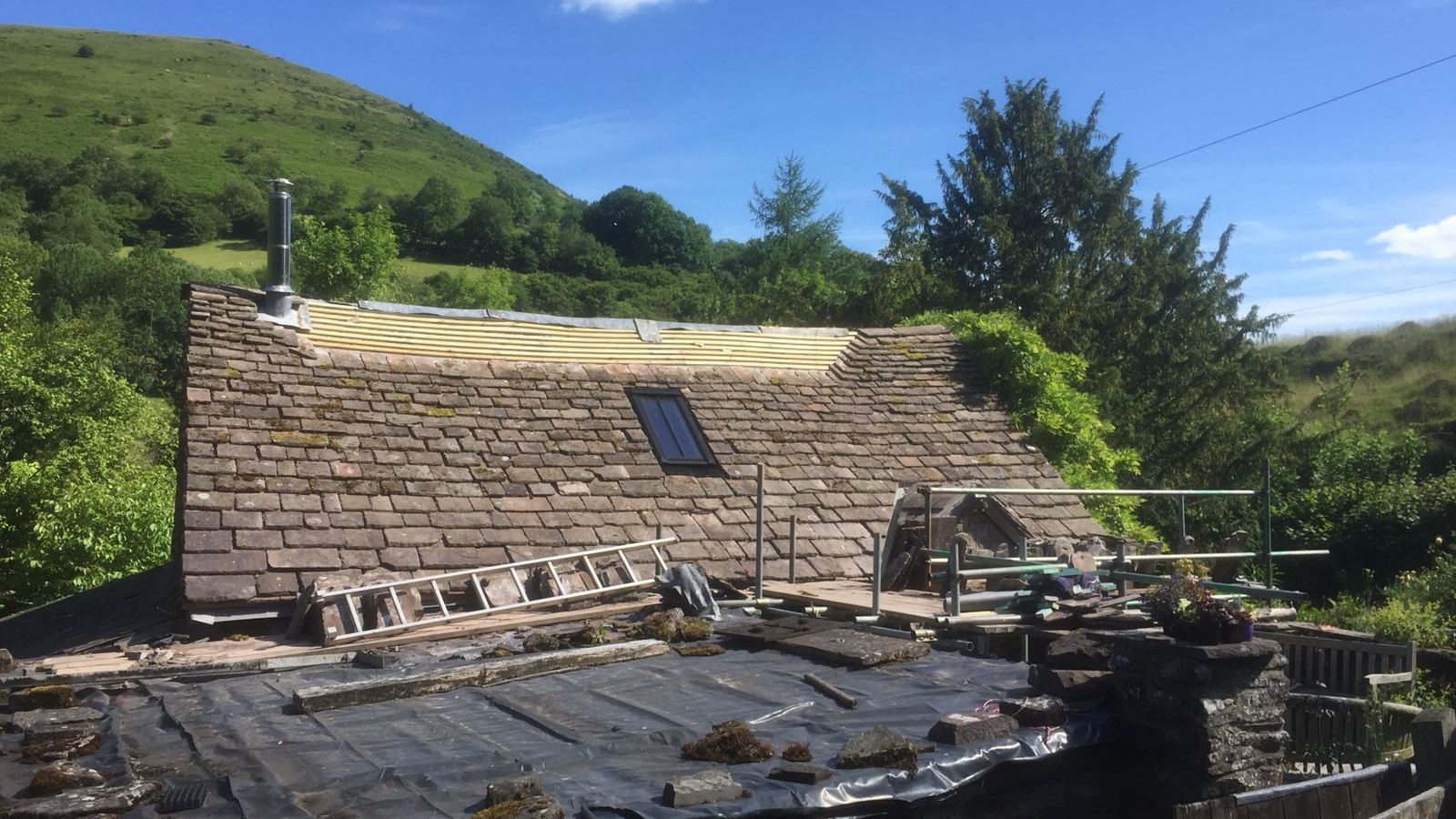A roof strip in progress below the Black Mountains