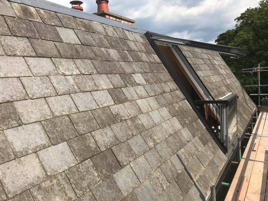 A slate roof with a dormer window