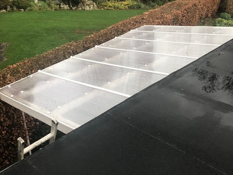 A flat roof beside a glazed canopy