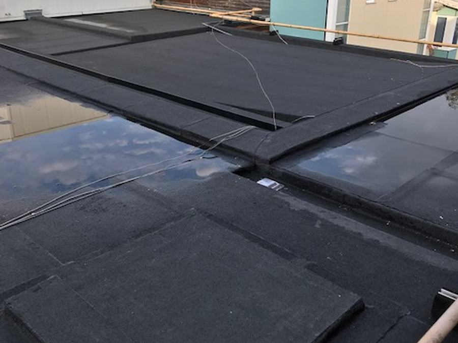 A dark felt flat roof on a domestic extension