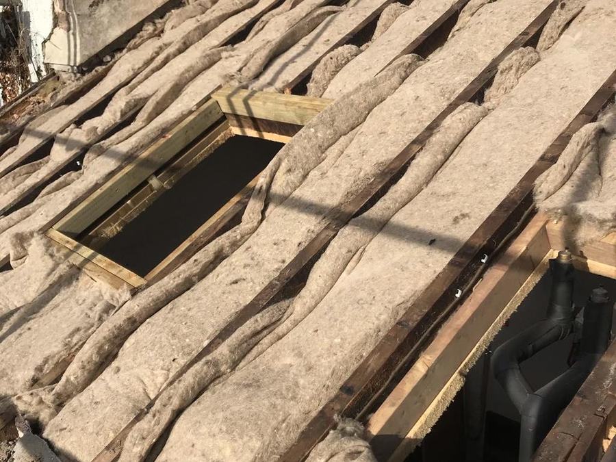 An old stone slate roof stripped back to the battens